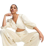Collective The Label Exclusive Twisted Cut-Out Jumpsuit In Oyster – jumpsuits & playsuits by Collective The Label, available to rent from Hirestreet