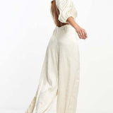 Collective The Label Exclusive Twisted Cut-Out Jumpsuit In Oyster – jumpsuits & playsuits by Collective The Label, available to rent from Hirestreet