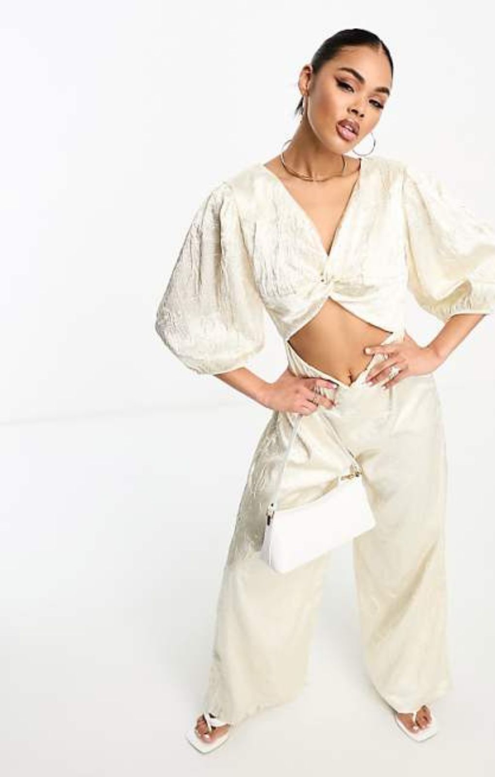 Collective The Label Exclusive Twisted Cut-Out Jumpsuit In Oyster – jumpsuits & playsuits by Collective The Label, available to rent from Hirestreet