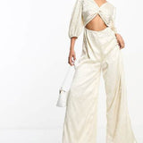 Collective The Label Exclusive Twisted Cut-Out Jumpsuit In Oyster – jumpsuits & playsuits by Collective The Label, available to rent from Hirestreet