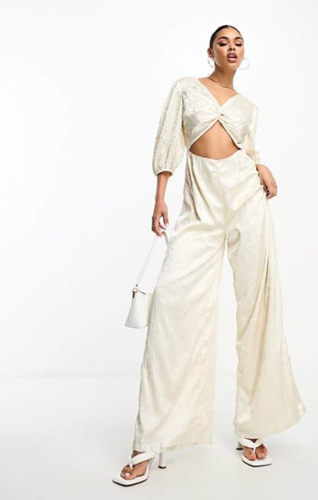 Collective The Label Exclusive Twisted Cut-Out Jumpsuit In Oyster – jumpsuits & playsuits by Collective The Label, available to rent from Hirestreet